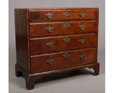 A George I walnut caddy top chest of four graduated drawers. Crossbanded, with original brightwork and raised on bracket feet