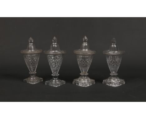 Two pairs of Georgian flat cut glass confitures and covers raised on square lemon squeezer bases, 19cm high.Condition report 