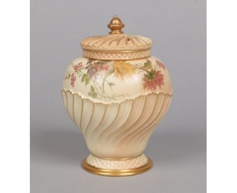 A Royal Worcester blush ground potpourri jar and cover of baluster form. Having wrythen moulded pierced cover with acorn fini