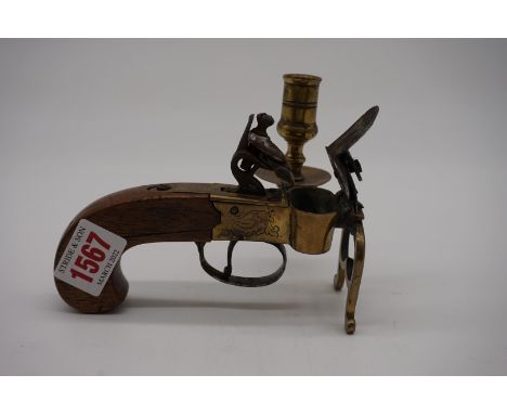 A Georgian brass flintlock tinder lighter, with attached candlestick. 
