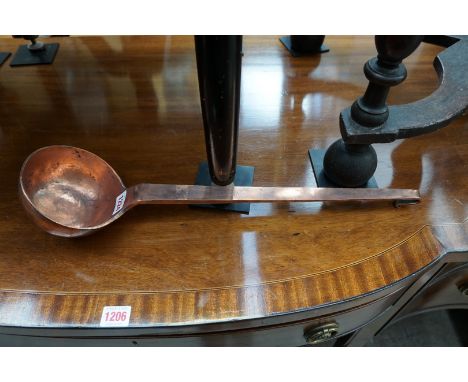 A large 19th century copper ladle, inscribed 'Jones Bros, Down St, Piccadilly, London', 52cm long.&nbsp; 