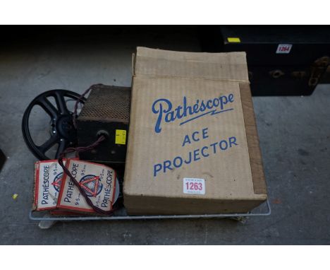 A Pathescope 'Ace' 9.5mm projector, boxed and with instructions; together with six boxed films, to include: 30359 'Mickey's J