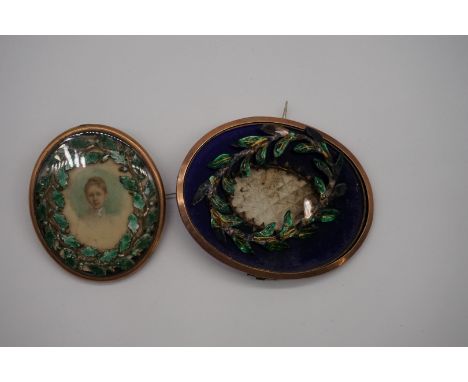 An antique&nbsp;gilt metal oval frame, with enamel oak leaf sleeve, 5.2 x 4.3cm; together with another. (2)  