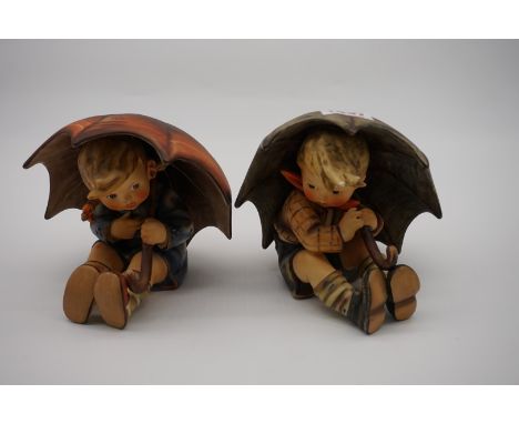A pair of Goebel figures of 'Umbrella Boy' and 'Umbrella Girl'.&nbsp; 