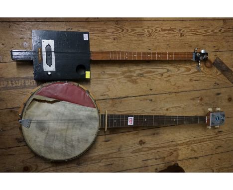 An old four string banjo; together with another stringed instrument. 