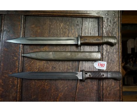 A German bayonet and steel scabbard; together with another similar bayonet.&nbsp; 