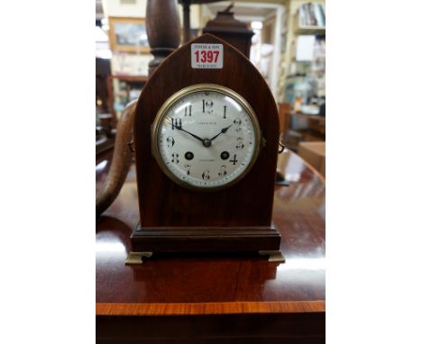 A late 19th century rosewood and line inlaid lancet form mantel clock, the enamel dial inscribed 'Maple &amp; Co Ltd', 25cm h