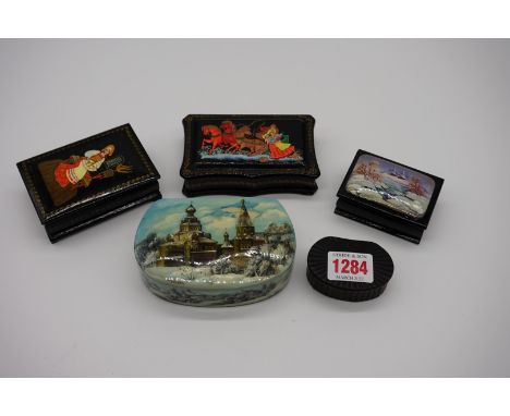 Four Russian papier mache boxes, largest 11cm wide; together with another Georgian papier mache snuff box, 6cm wide. (5) 