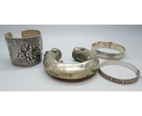 Two silver bangles, an Eastern metal torque bangle and a Danish white metal bangle