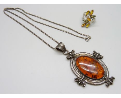 A large statement silver pendant set with amber on a silver chain, together with a silver and amber ring, pendant and chain 4