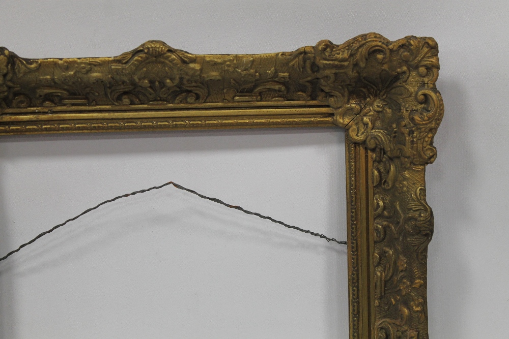 A DECORATIVE GILT ANTIQUE PICTURE FRAME 42cm X 52cm EXTERNAL AND 30cm X
