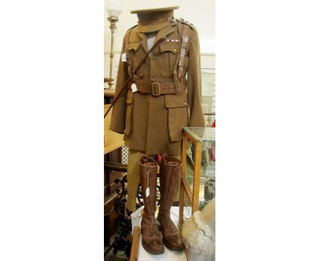 A rare WWI Officers Uniform. Consisting of cap, jacket, swagger stick, Sam Browne belt, breeches, boots and tin. Rank insigni