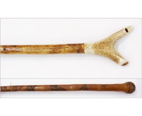 A shepherd's walking stick with whistle and another stick with animal  carvings 