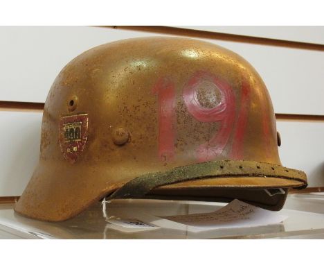 A WWII German army M40 helmet with leather inner and neck strap 
