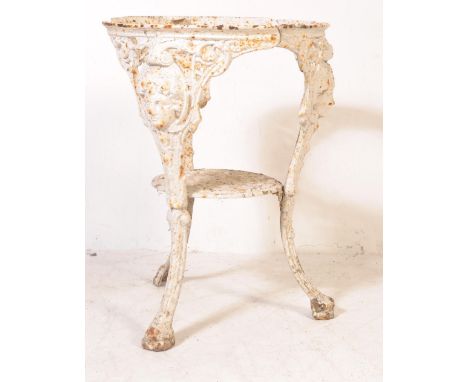 A vintage 20th century cast metal Britannia tavern pub table of circular form having tripod supports with a female features t