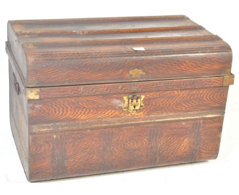 A retro vintage industrial mid 20th century trunk having a hinged lid opening to reveal a spacious interior with carry handle