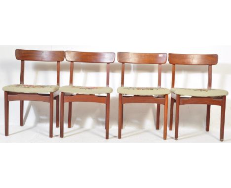 A set of four 1960's Danish influence retro vintage teak wood dining / side chairs having shaped bar back rests with retro fl