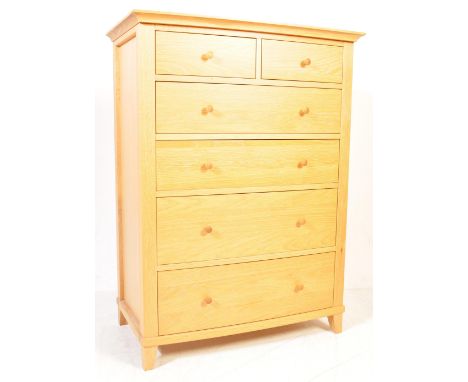 A good contemporary blond oak bedroom chest of drawers of bow fronted form. Raised on squared legs with a tall upright body o