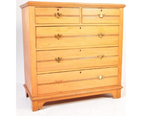 An Edwardian satin walnut chest of drawers. The chest being raised on squared legs with 2 short drawers over 3 deep drawers b