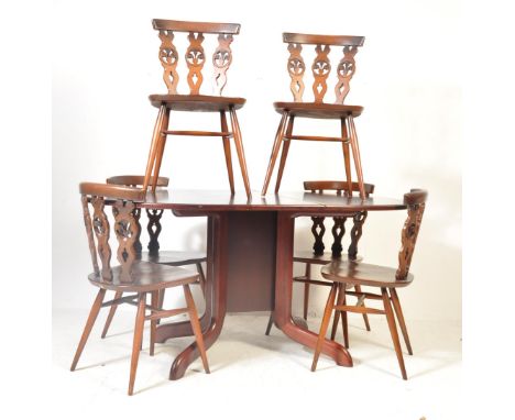 Early 20th century dining suite. The suite comprising of six dark elm dining chair by Ercol having curved top rail with pierc