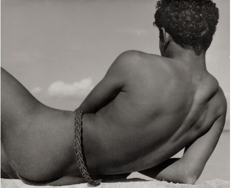 List, Herbert -- Young man on the beach. 1950s. Vintage gelatin silver print. 22,3 x 27,5 cm. Photographer's stamp and annota