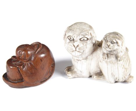 Japanese wooden netsuke and ivory netsukeMeiji/Taisho periodThe wooden netsuke carved as a sitting Buddha resting his head on