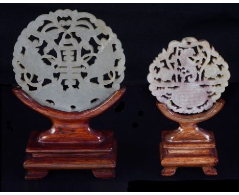 Two Chinese jade round plaques 19th centuryCarved in openwork as a basket of flowers and dragon and as auspicious symbols of 