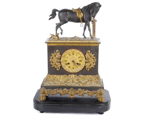 A 19th Century Russian Clock:The cast spelter figure to the top of a horse with saddle tied to a post about to kick a dog at 