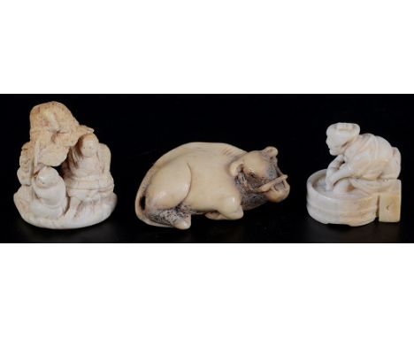 Three Meji period netsuke, one ivory with two owls, one ivory of washerman &amp; a bone recumbent ox