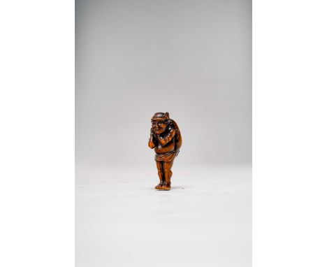 A LARGE JAPANESE WOOD NETSUKE OF A FISHERMAN MEIJI ERA, 19TH/20TH CENTURY  Depicted standing, wearing a loincloth and a hachi