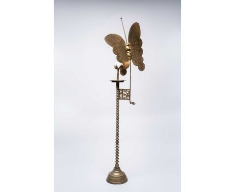 A KOREAN BRASS CANDLESTICK WITH BUTTERFLY20TH CENTURYThe tall stem raised on a stepped base and with a large butterfly reflec