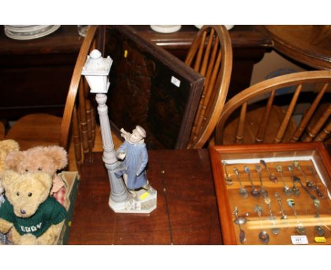 A Lladro figure of a lamp lighter; and a copper embossed picture of a tiger 