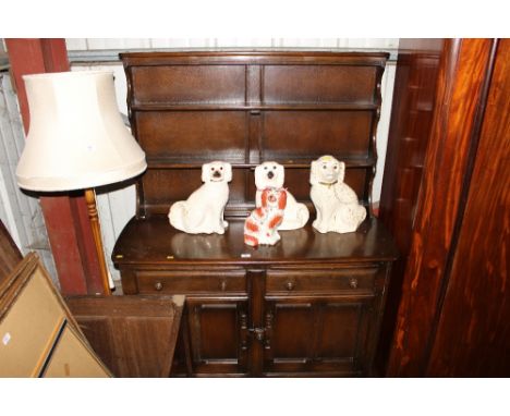 A dark Ercol kitchen dresser fitted two drawers 
