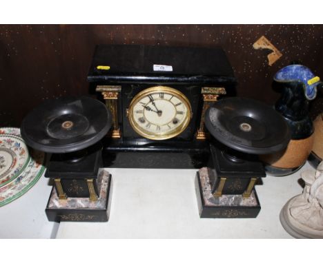 A 19th Century mantel clock with a pair of black slate and marble garnitures