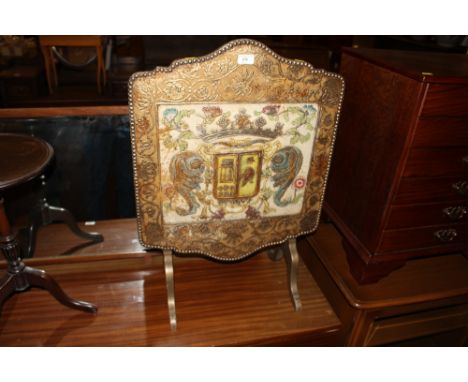 A painted and decorated folding fire screen 