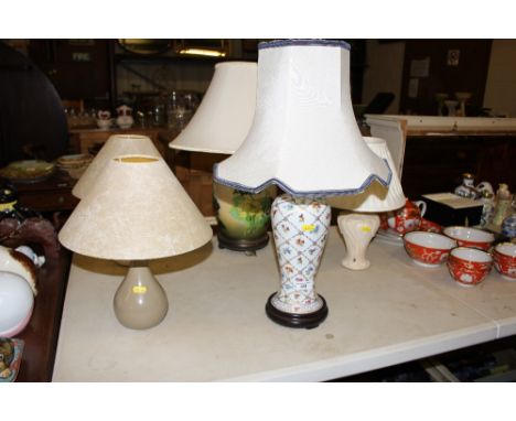 A continental porcelain floral decorated table lamp; together with four various other table lamps 