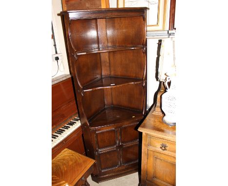A dark Ercol corner cupboard 