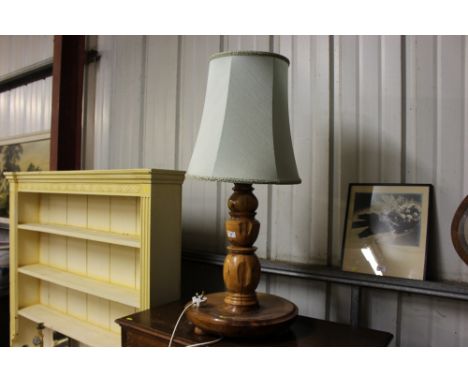 A turned wooden table lamp and shade