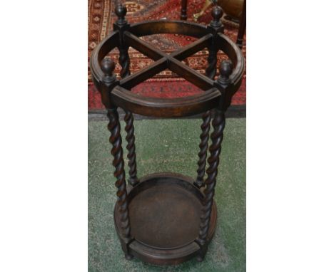 An early 20th century oak stick stand, barley twist supports