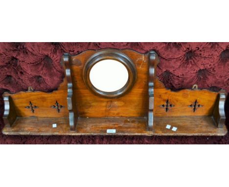 An early 20th century mahogany wall shelf, inset circular mirror, 102cm wide