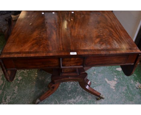 A Regency mahogany crossbanded dropleaf sofa table, rounded rectangular top above a pair of frieze drawers, square pillar, br