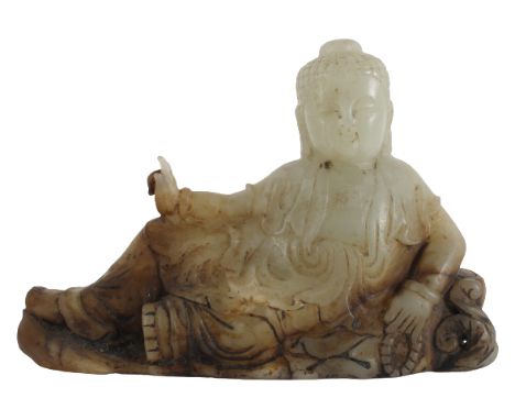 Chinese Translucent Pale Green Jade Buddha. Late Qing Dynasty, in a Ming style. Reclining on a lily pad, the Buddha’s right h