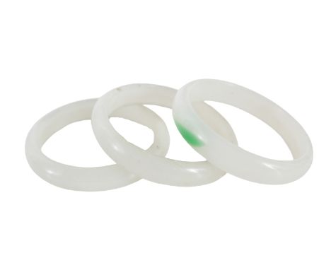 Three Chinese Translucent White Jade Bangles. Two with no inclusions, the third, with a streak of emerald green Size: 2 3/4 i