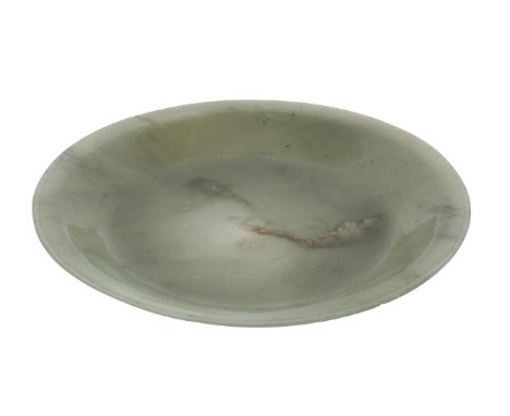 Early 20th Century. The circular dish with deep recess and flared rim, light green with dark green inclusions. Size: 6 5/8 in
