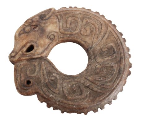 Both ends carved as an open-mouthed serpent head, the body with raised stylized scrolls suggesting scales, beige to brown in 