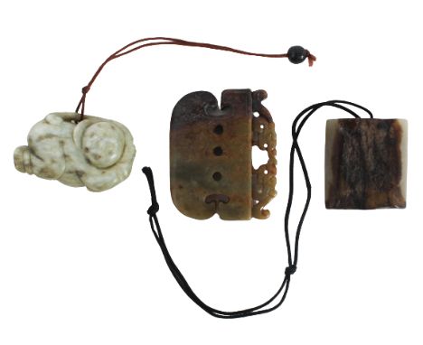 Qing Dynasty, 19th Century. The first, a pierced ax form plaque surmounted by two facing dragons, of moss green color with ar