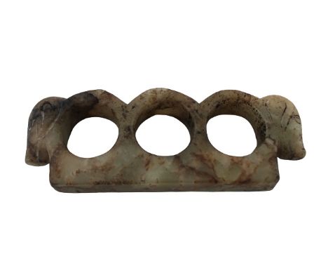 Chinese Jade Tekko Knuckles The green and brown mottled jade carved with three finger loops, each end terminating into a hog’