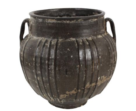 Tang Dynasty Brown Glazed Earthenware Seed Jar. Of tapered spherical form with vertical ribs, and two molded loops for handle