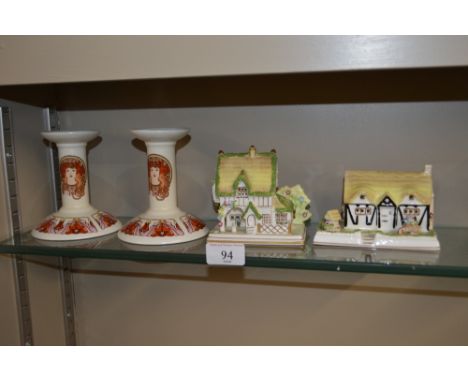 A pair of Poole Pottery Fleurie candlesticks and two Coalport model cottages 