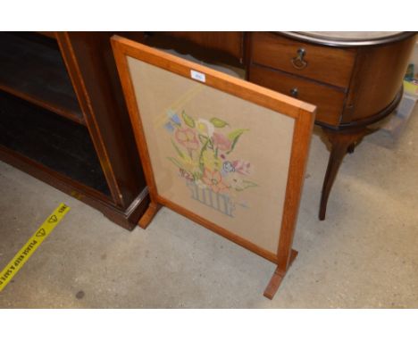 An oak frame and needlework firescreen